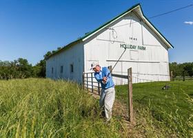 Pete Dye swinging first club at Holliday Farms.